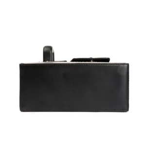 Detail view of black structured box bag, durable material, clean stitching, portable design.