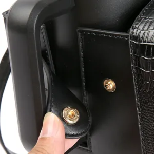 Black crocodile pattern water bottle bag adjustable shoulder strap detail close up accessory