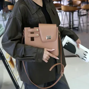 Stylish leather shoulder messenger bag with metal clasp and cutout strap design for daily wear.