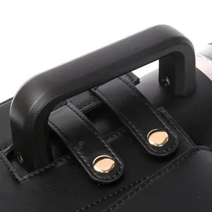 Water bottle bag detail showing durable handle, black leather texture and gold metal snap.