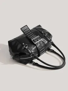 Black studded motorcycle handbag detail, vintage punk style shoulder bag hardware close up.