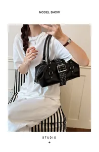 Black leather rivet shoulder bag, edgy biker style handbag with chic metal buckle and top handle.
