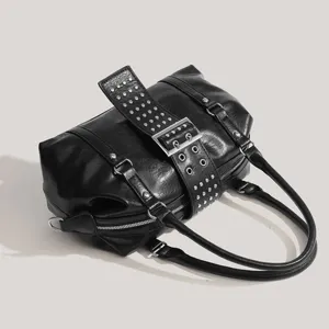 Black motorcycle shoulder bag with metal rivets and buckle design for chic daily commuting style.