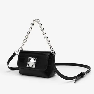 Detailed view of the black chic square shoulder bag with metal bead handle and clasp.