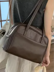 Detailed view of women's vintage dark brown shoulder bag, spacious tote design for autumn.