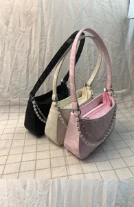 Detail shot of Korean style quilted shoulder bag with pearl and metal chain straps.
