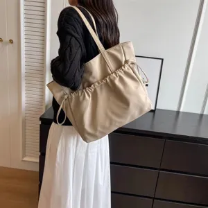 Large capacity beige tote bag for women, casual commuter shoulder bag with drawstring.