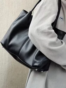 Minimalist black tote bag for women, large capacity shoulder handbag for daily use.