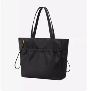 Minimalist black tote bag for women, large capacity shoulder bag with drawstring pocket.