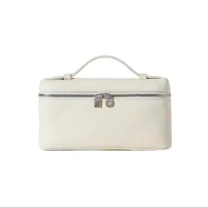 Detail view of white PU vanity bag with double zip and top handle, elegant texture design