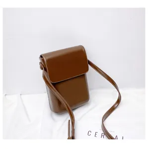 Brown mini vertical crossbody phone bag, stylish minimalist PU leather shoulder bag detail.