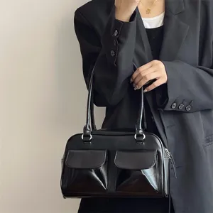 Black patent leather shoulder bag with dual front pockets, elegant vintage design for daily wear.
