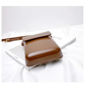 Mini vertical crossbody phone bag for women and men, retro brown PU leather shoulder bag.