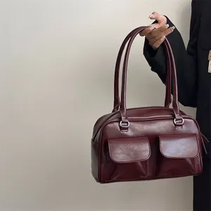Retro burgundy shoulder bag with dual front pockets and top handles for women daily commute.
