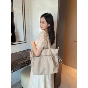 Simple large capacity beige tote bag for women, lightweight commuter shoulder bag for daily use.
