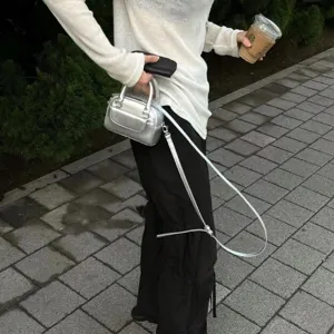 Silver metallic mini handbag for women, stylish shoulder crossbody bag with top handle.