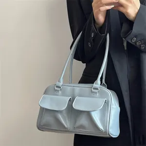 Detail view of light blue PU leather shoulder bag featuring dual front pockets and retro design.