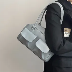 Chic light blue shoulder bag for women, retro commuter tote with dual pockets and straps.