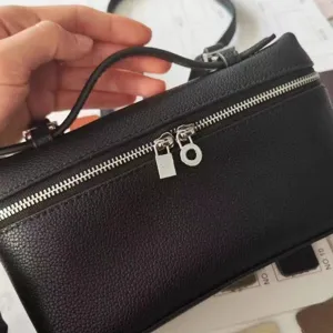 Black litchi pattern PU leather vanity handbag with metal zipper and top handle design.