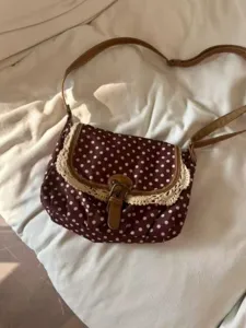 Vintage brown polka dot canvas shoulder bag with delicate lace trim and retro crossbody strap.