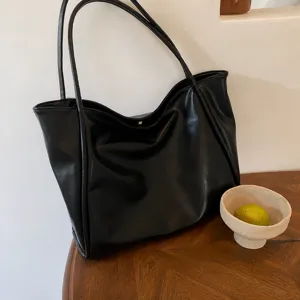 Fashion black PU leather tote bag for women, large capacity casual shoulder handbag daily use.