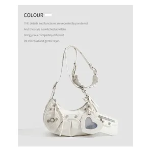 White crocodile pattern crescent shoulder bag detail with metal studs and heart mirror.