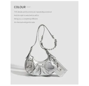 Silver metallic hobo shoulder bag featuring stylish heart mirror and metal rivets detail