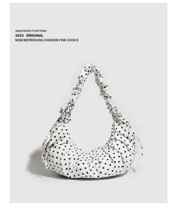 Polka dot dumpling bag canvas detail, stylish scrunchie strap and drawstring design.