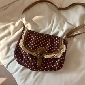 Korean retro polka dot canvas shoulder crossbody bag with elegant lace trim for women daily.