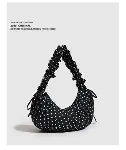 Detailed view of the black and white polka dot hobo dumpling bag with stylish ruched strap.