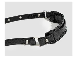 Black crocodile pattern shoulder bag strap detail with metal rings and studs for women.