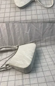 Korean style white underarm bag with pearl and metal double chains detail shot.