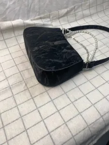 Stylish black underarm shoulder bag for women with chic pearl and metal chain straps daily.
