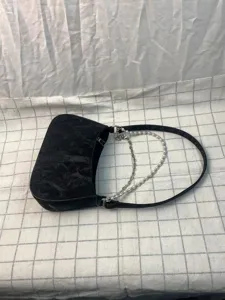 Black chic underarm bag for women with pearl metal double chains and quilted texture.