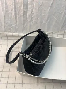 Black quilted shoulder bag detail, elegant pearl and metal double chains, chic y2k style.