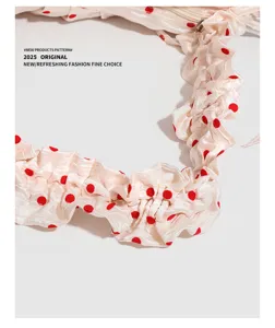Detailed view of ruffled polka dot shoulder bag showcasing unique pleated texture and red dots.