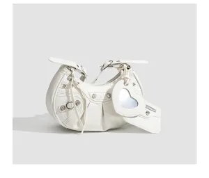White crocodile texture hobo bag detail, featuring metal studs, buckles, and heart mirror.