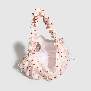 Chic ruched polka dot dumpling crossbody handbag with zipper for women daily commute.