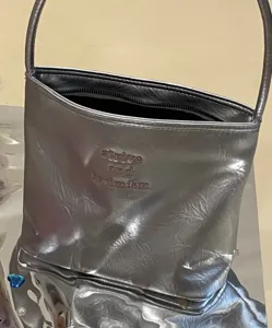Stylish silver metallic shoulder bag for women, featuring chic letter embroidery and strap.