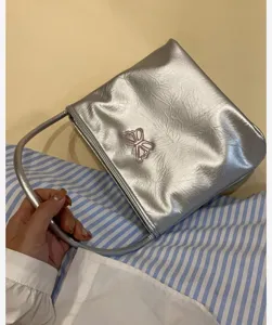 Silver metallic shoulder bag with pink butterfly embroidery for women, trendy daily accessory.