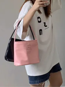 Korean style minimalist shoulder handbag detail view, casual pink and black leather tote bag.