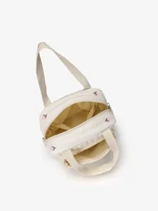 Quilted handbag detail view, off-white fabric with cute floral embroidery and secure dual zippers.