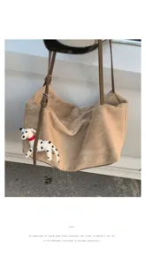 Detailed view of the casual suede shoulder bag with cute puppy pendant and smooth zipper.