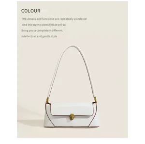 Elegant minimalist white baguette shoulder bag with gold hardware and contrast edge detail.