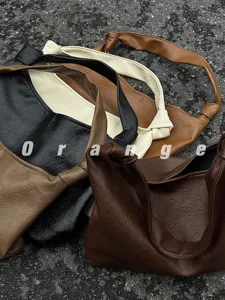 Detail shot of soft PU leather slouchy hobo shoulder bag with stylish knotted strap design.