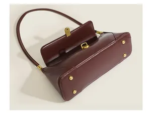 Vintage brown baguette shoulder bag for women, elegant chic underarm purse with golden lock.