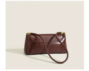 Vintage brown leather baguette shoulder bag for women, chic retro underarm handbag.