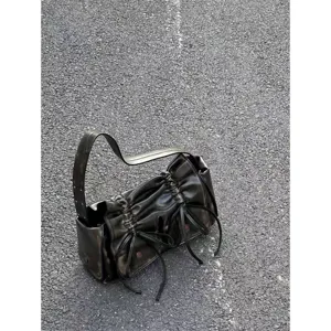 Detailed shot of dark metallic pleated drawstring shoulder bag with multi pockets and cool style.