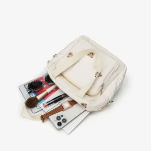 Quilted tote bag for women, cute bear embroidery casual shoulder handbag with daily accessories layout.