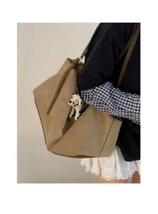 Detailed view of the casual suede shoulder bag, showcasing its soft texture and large capacity.